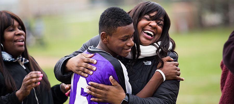 Tamie cheering on her son at his soccer game