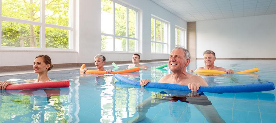 Group of people taking a water aerobics class