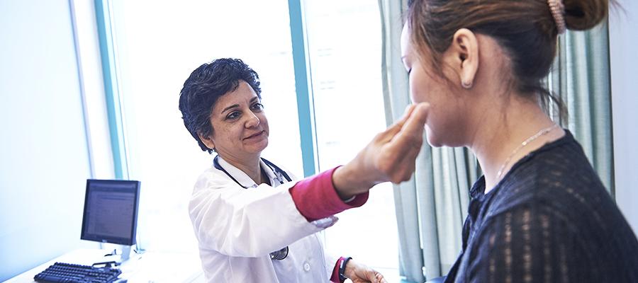 Doctor evaluates patient in room