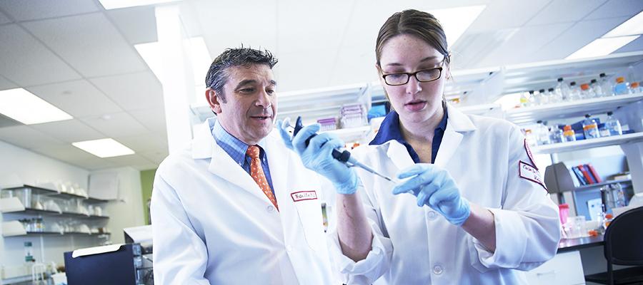 Walter Koch, PhD overseeing research in a lab 
