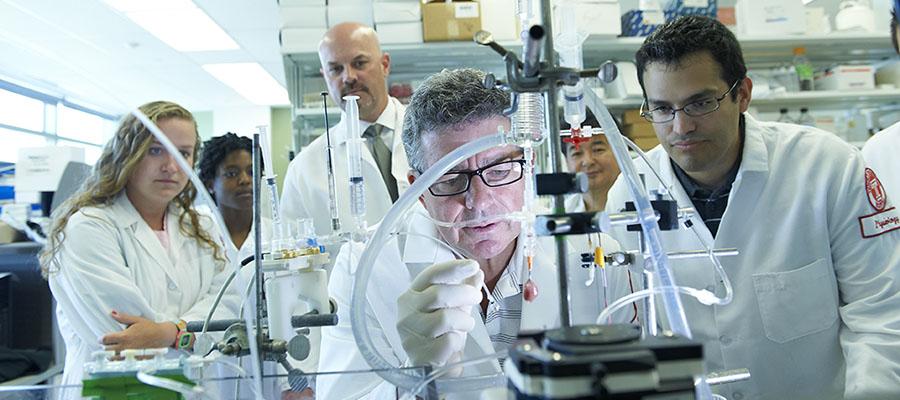 Dr. Houser conducting research with his students