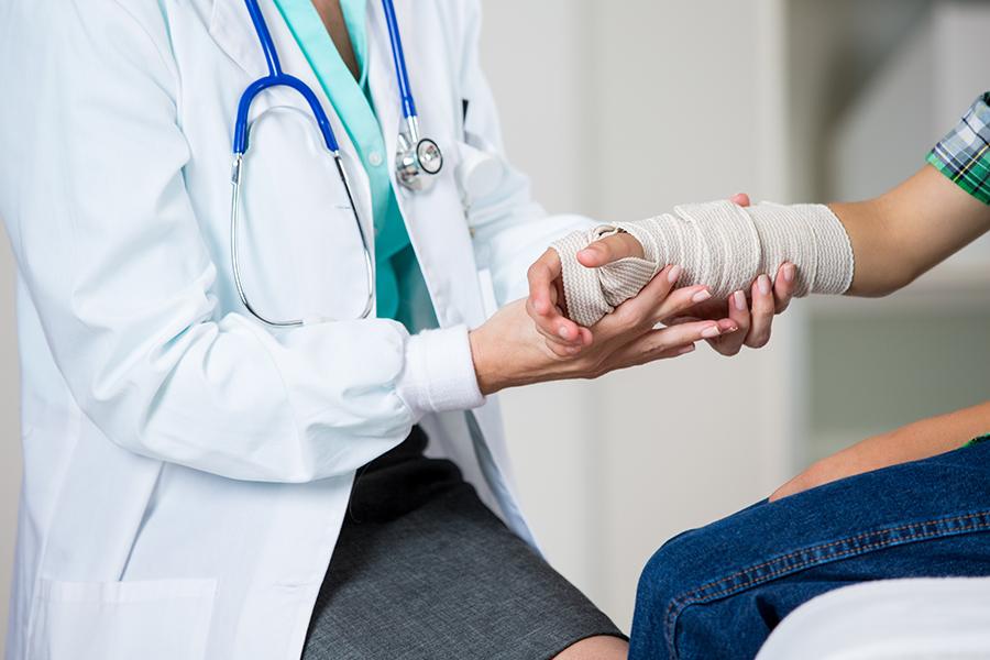 Doctor wrapping a patient's injured wrist