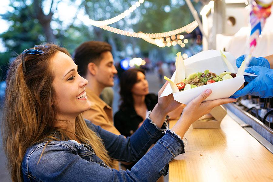 Woman buying meal from food truck