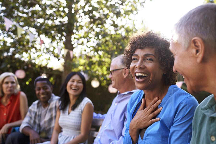 Diverse group of friends socializing in the backyard
