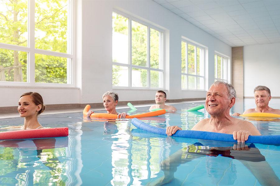 Group of people taking a water aerobics class