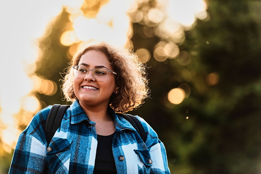 Younger woman smiling outside