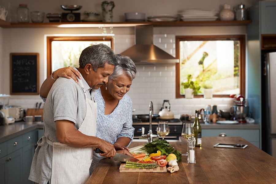 Couple cooking healthy meal in kitchen