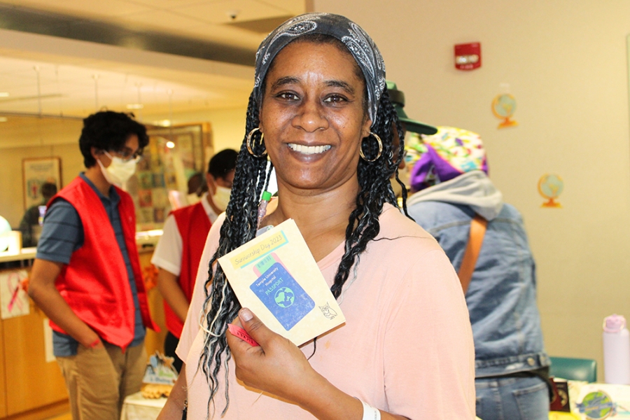 Woman holds up literature.