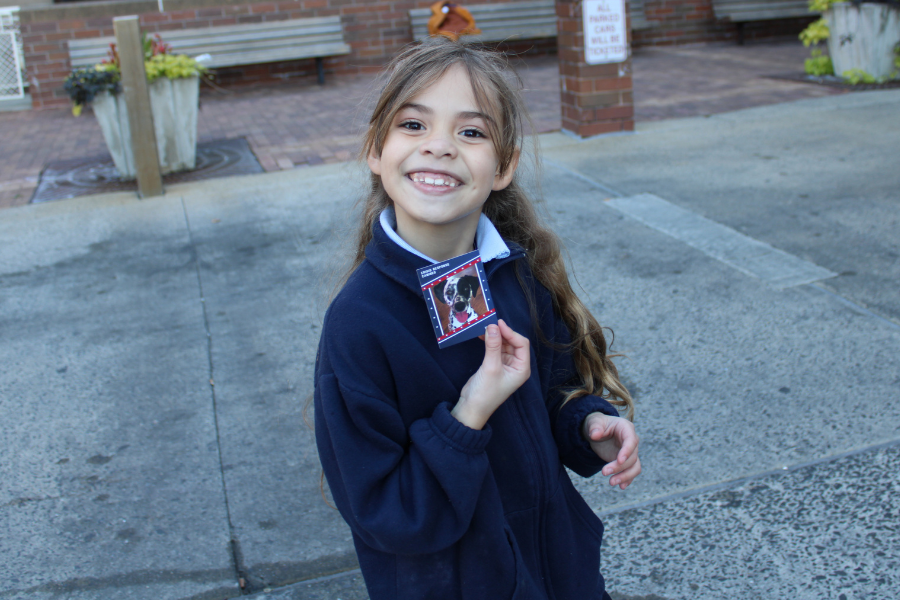 A Bethune Elementary School student with a photo of Kona, one of the Crisis Response Canines that attended the event. 