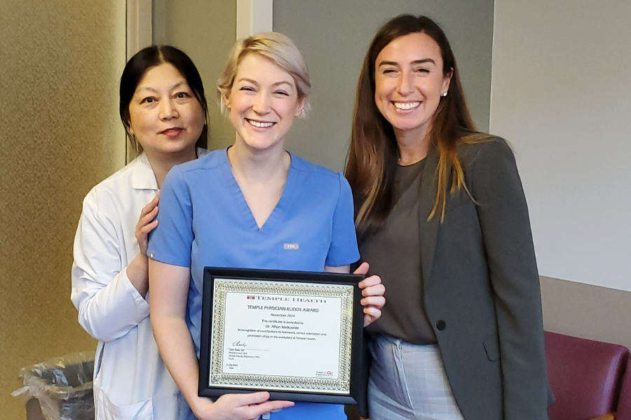 Dr. Sylvia Hsu, Chair of the Department of Dermatology, and Claire Raab, MD, President & CEO of Temple Faculty Physicians, present the Faculty Kudos Award to Dr. Metkowski.