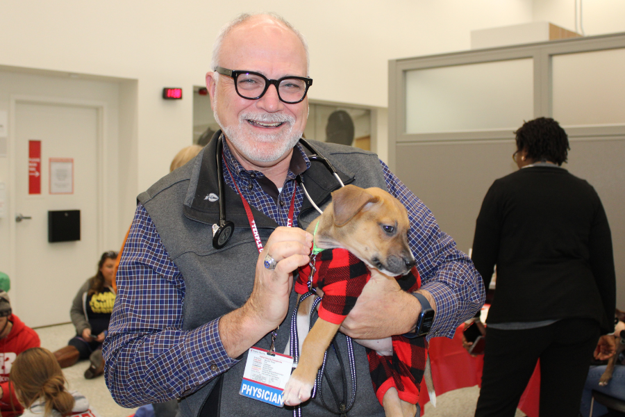 Daniel Edmundowicz, MD, MBA, FACP snuggles an adorable puppy.