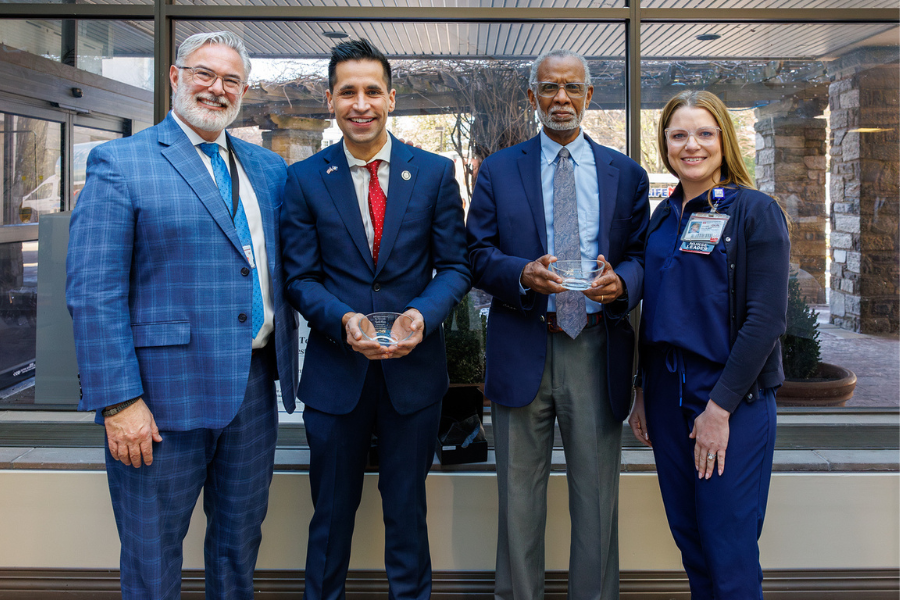 State Senator Haywood (center left) and Representative Khan (center right) with their commemorative tokens. 