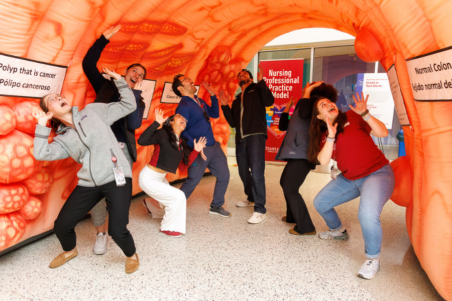  Our team members take a playful picture inside the giant inflatable colon, which showed sections of abnormal growths that could progress into cancer if left untreated.