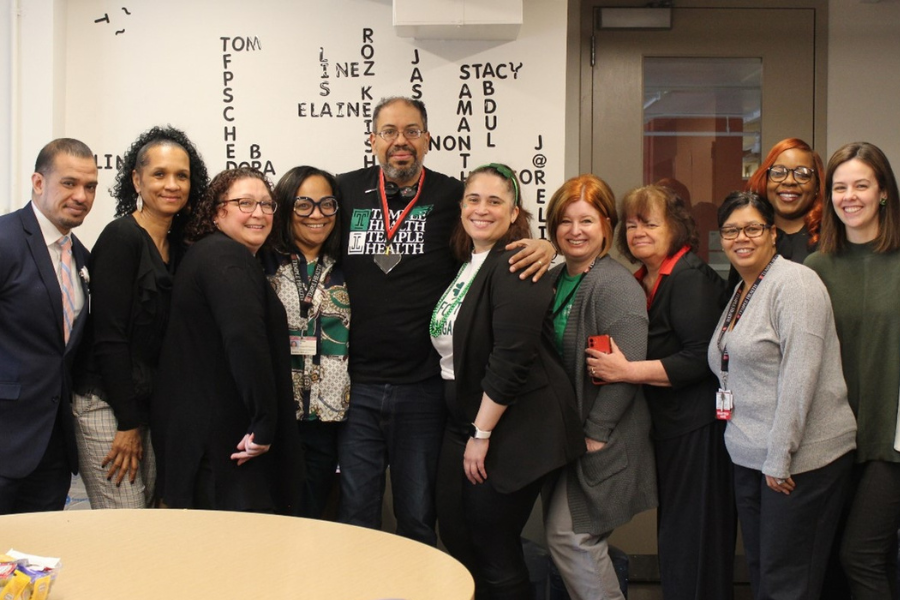 Hector (center left) celebrates his TFP C.A.R.E.S. Award with team members.