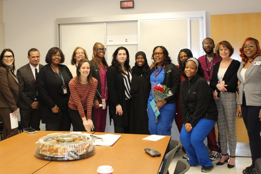 Nina (sixth from right) celebrates her TFP C.A.R.E.S Award with friends and colleagues.