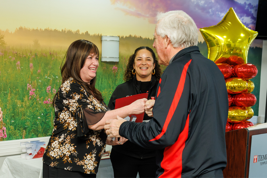Chemistry Lab Manager Lori Kubala shares a fist bump with Temple Health President & CEO Michael A. Young, MHA, FACHE. 