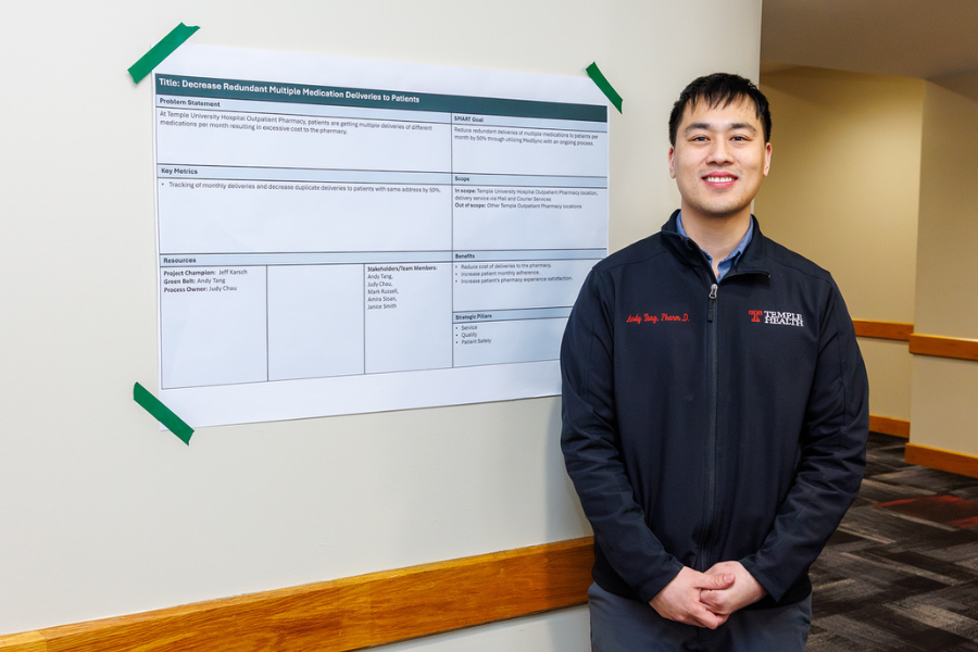 Andy Tang, Manager of the TUH-Main Campus Outpatient Pharmacy, with his poster on his project, "Reduction in Duplicate Pharmacy Deliveries (Mail & Courier)."