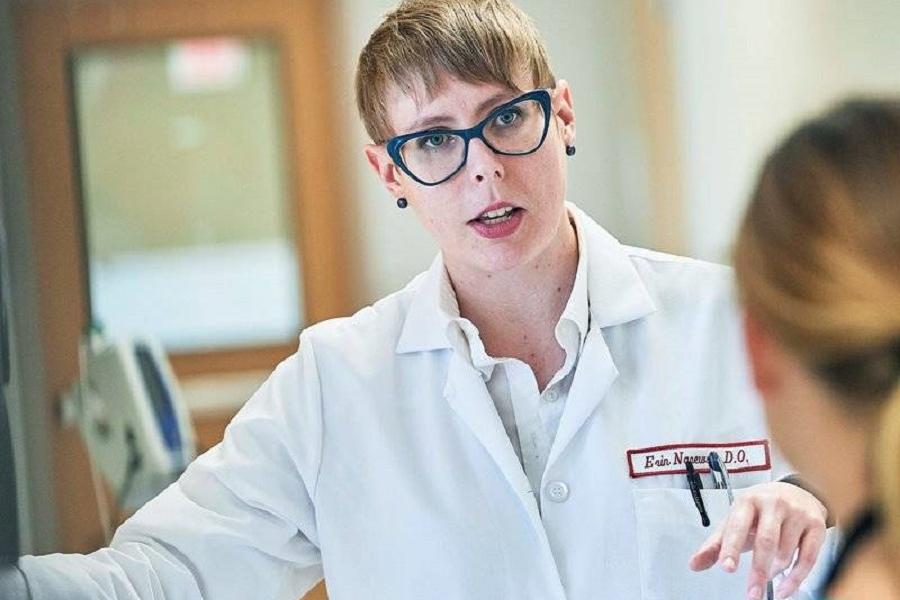 Dr. Erin Narewski talking to another physician in the hospital