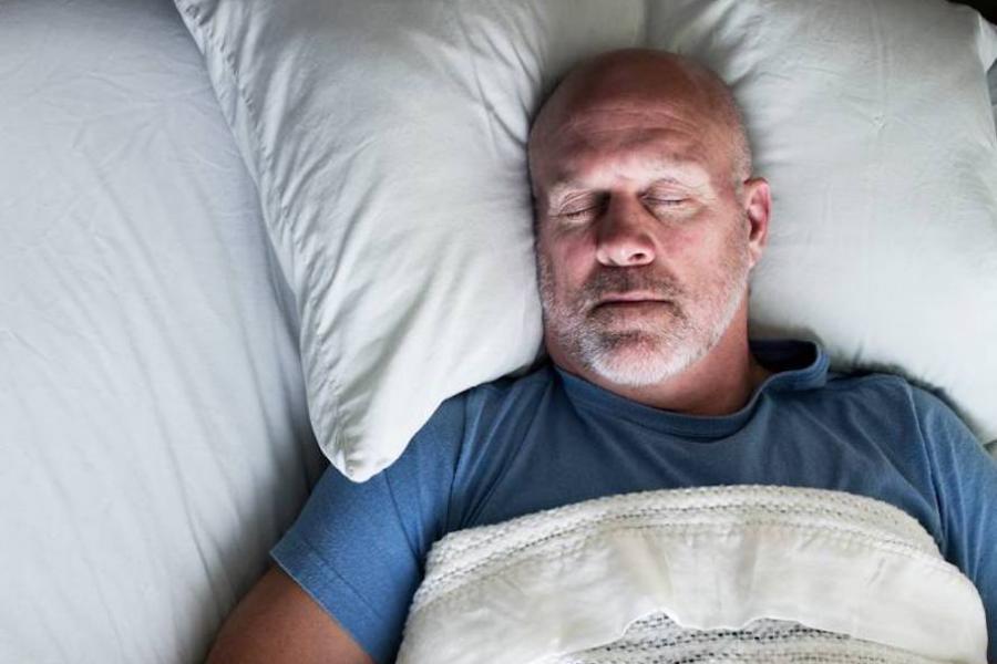 Closeup of man sleeping in bed
