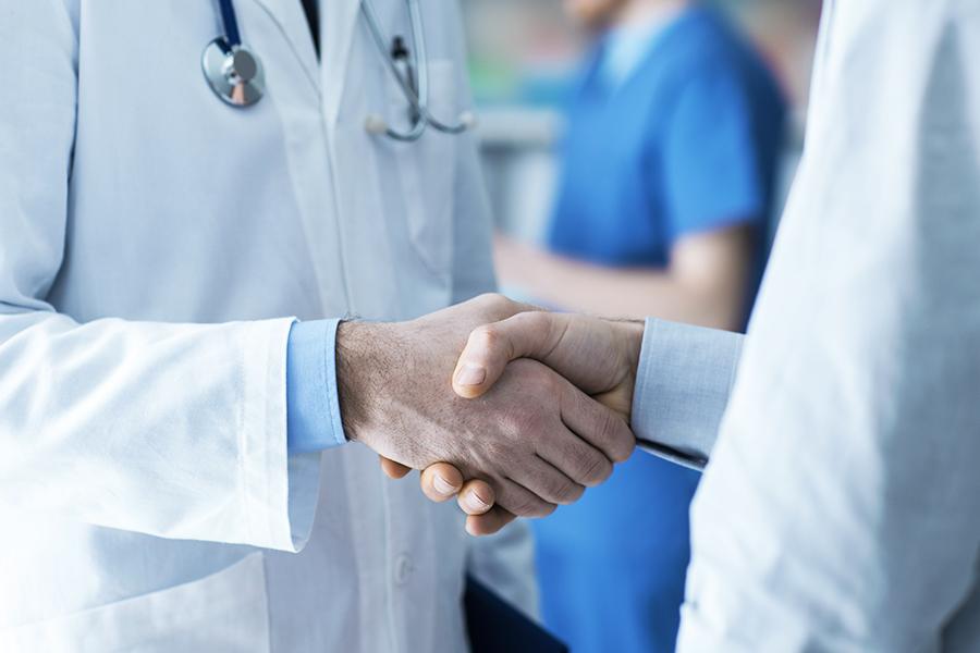 Two doctors shaking hands