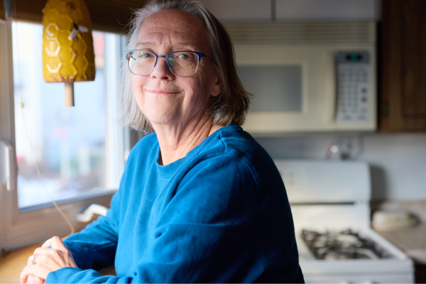 Cathleen smiling in her kitchen