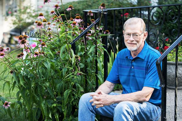 Robert H., Tracheobronchomalacia patient sitting on the steps of his house