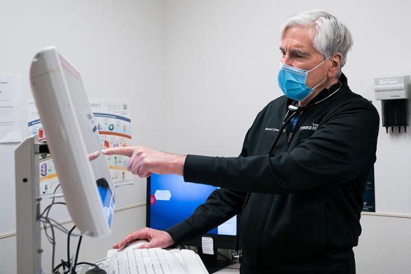 Dr. Gerard Criner looking at a COPD patient's medical record on screen
