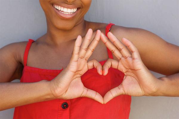 Women making a heart shape with her hands