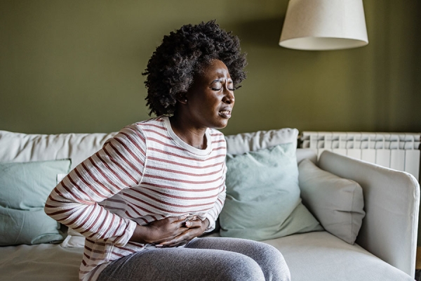 Woman holding stomach in pain