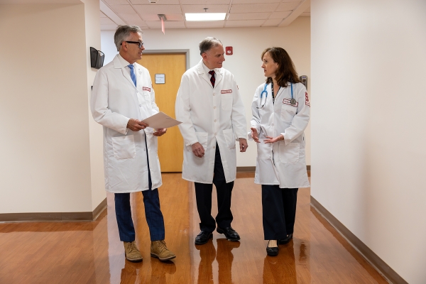 3 physicians in hallway