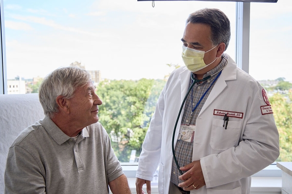 Dr. Nathaniel Marchetti talking with patients