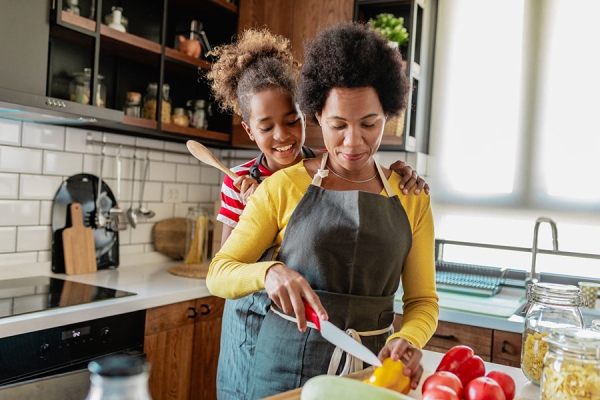Mother and daughter cooking healthy meal