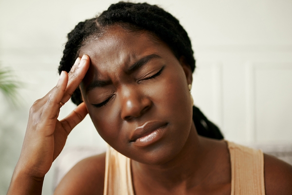 Woman holding face in pain