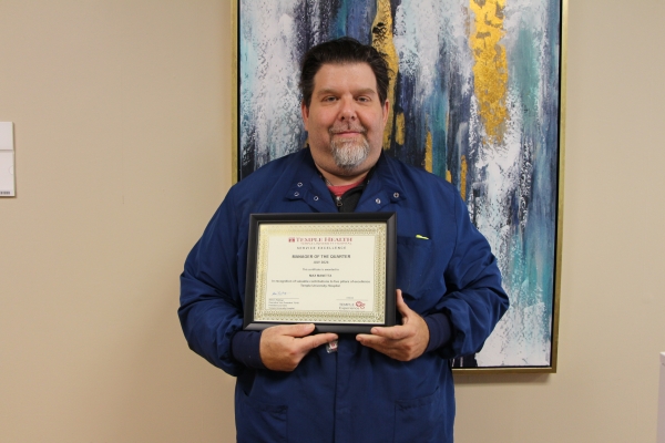 Max Manetta, MPH, with his Manager of the Quarter Award.