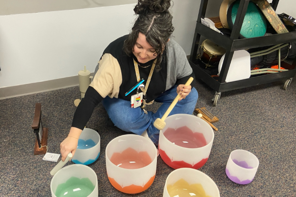 Burns plays the singing bowls, which she used during the sound bath meditation.