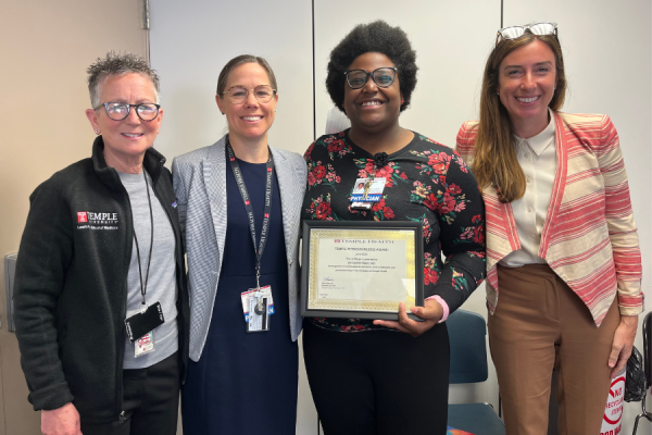 Dr. Bernadette Baker (center right) receives her TFP Kudos Award from Amy J. Goldberg, MD, FACS, The Marjorie Joy Katz Dean of the Lewis Katz School of Medicine (far left), Dr. Nina O’Connor (center left), and Claire Raab, MD, President & CEO of Temple Faculty Physicians (far right).