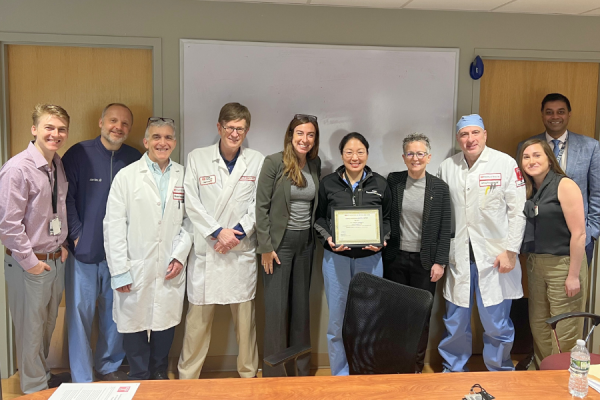 Dr. Laura Douglass (center right) receives her TFP Kudos Award from Amy J. Goldberg, MD, FACS, The Marjorie Joy Katz Dean of the Lewis Katz School of Medicine (third from right) and Claire Raab, MD, President & CEO of Temple Faculty Physicians (center left), with Dr. Jay Simhan on the far right.