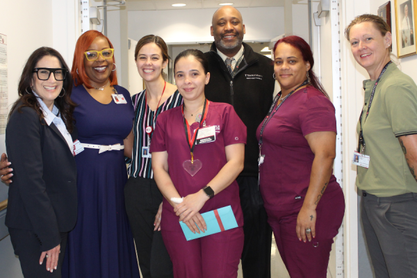 Vicmary Camacho celebrates her TFP C.A.R.E.S. Award with her colleagues.