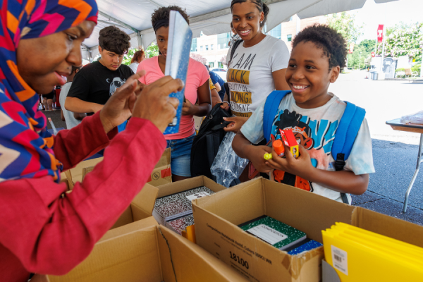 Employees distributed resources, information, and school supplies.