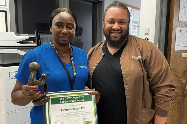 Mabinty and her coworker at her DAISY Award recognition ceremony.