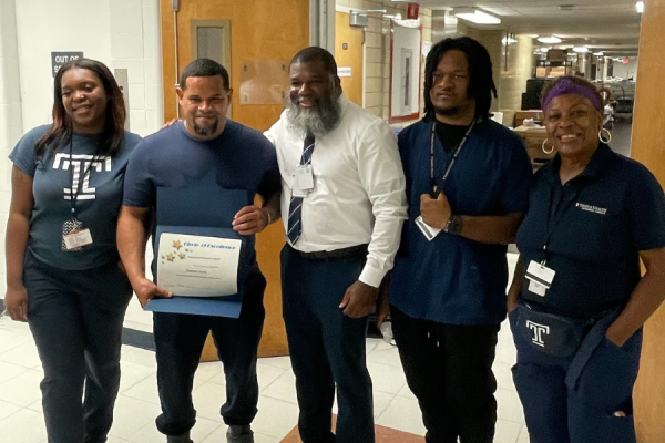Francisco Nunez (center left) receives his Exceptional Employee Award.