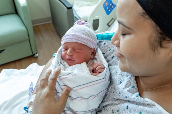 Romeo being held by his mom