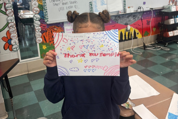 A third grader at Julia de Burgos Elementary School with her ‘Thank You Temple’ sign.