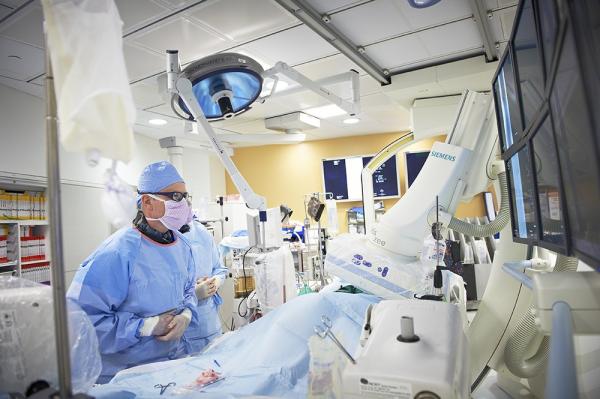 Physicians performing surgery in operating room