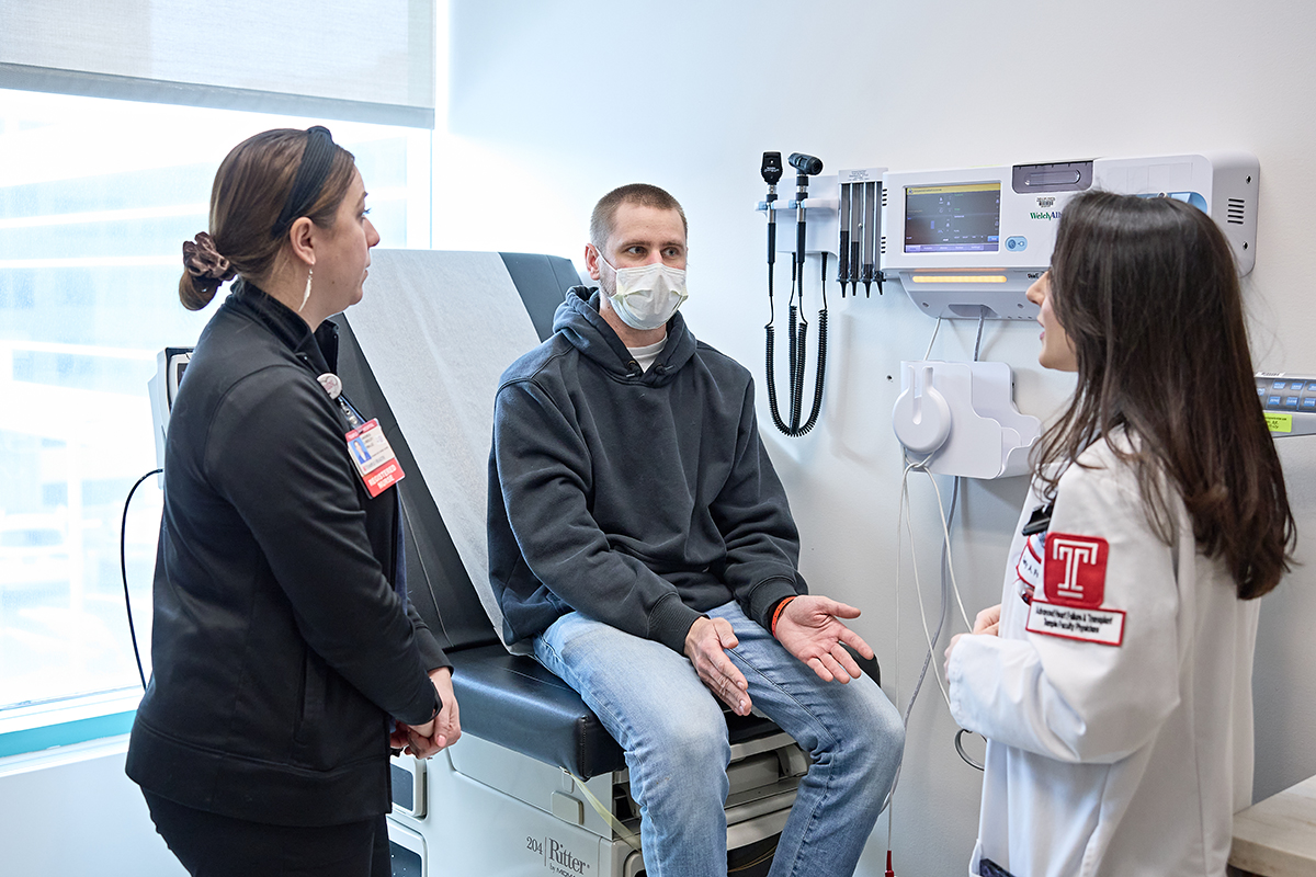 patient with two medical professionals