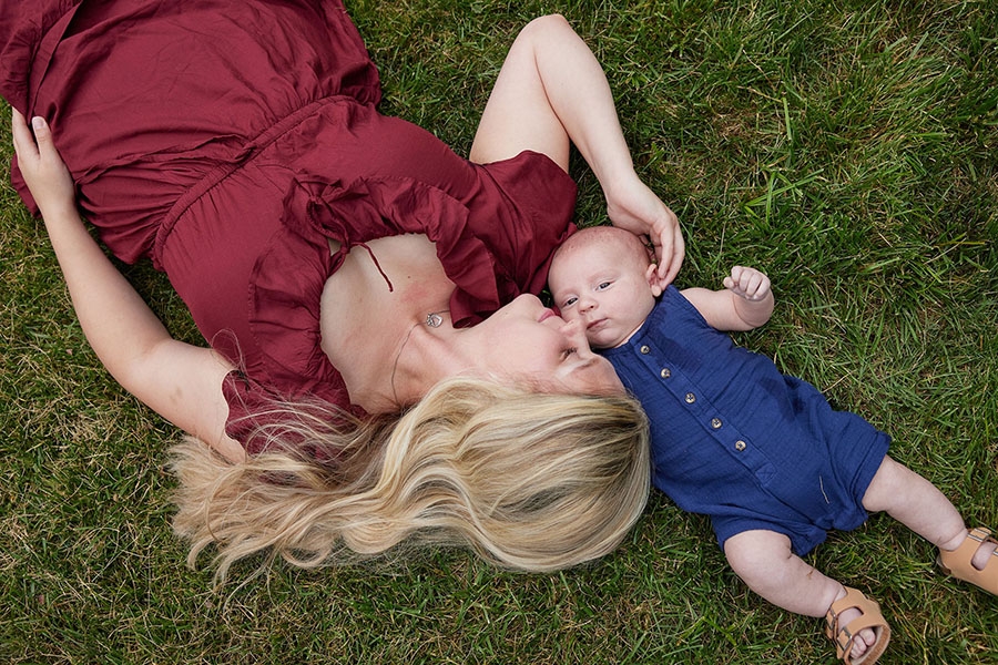 Mom laying in grass with her baby