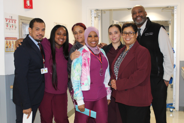 Dominique Newell (center) celebrates her TFP C.A.R.E.S. Award with her colleagues.