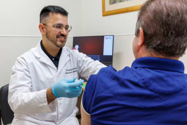 Ali Shahbaz, Manager of the TUH-Episcopal Outpatient Pharmacy, administers a long-acting injectable medication.