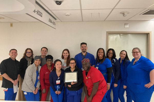 Lovejoy Paltu-Ob (center) celebrates her Service Excellence Employee of the Month Award with her colleagues.